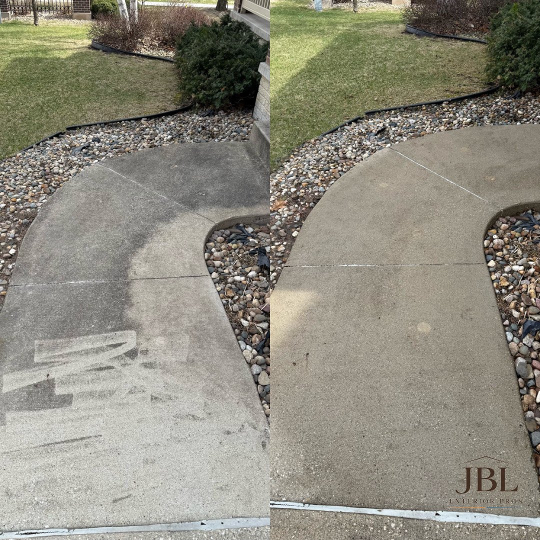 Power washing a sidewalk